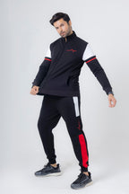 Man wearing a black and red tracksuit on a white background