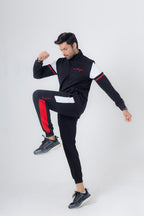 Person wearing a black and red tracksuit on a white background