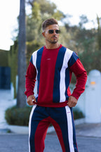 Nextage Man wearing a red, white, and blue striped outfit outdoors.
