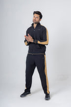 Man wearing a black and gold tracksuit on a white background