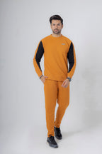 Man wearing a mustard yellow and black outfit on a white background