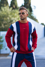 Nextage Man wearing a red, white, and blue striped outfit with sunglasses outdoors.