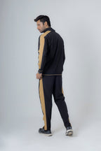 Person wearing a black and beige tracksuit on a white background