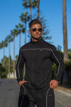 model wearing nextage clothing black sweatshirt with embroidered logo and white piping detail