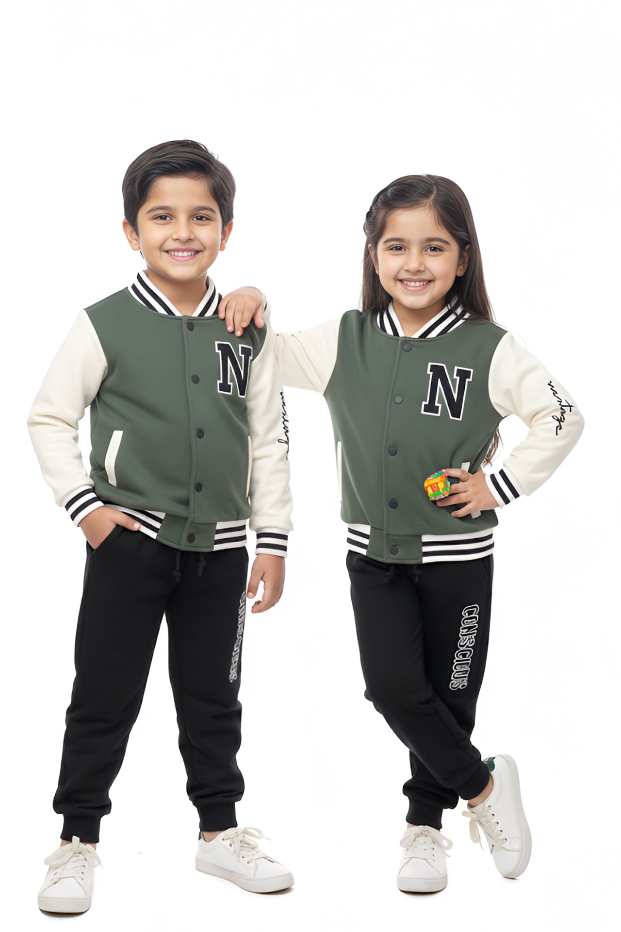 Two children wearing matching green letterman jackets with a logo on a white background