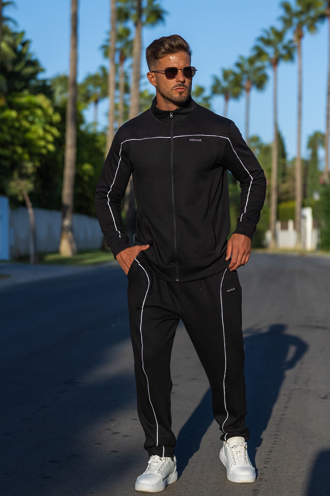 Model wearing Nextage black piping detail cotton fleece tracksuit