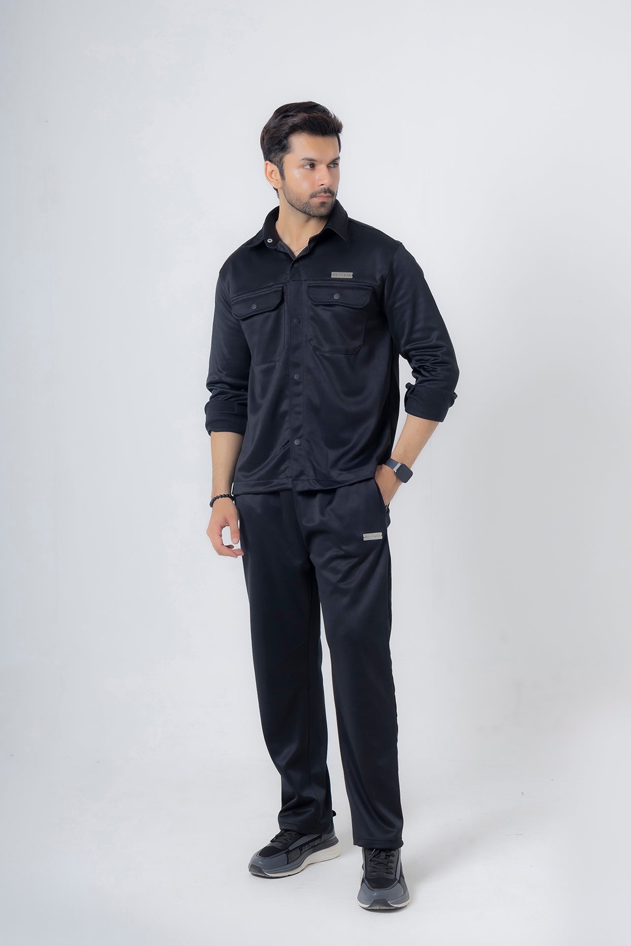 Man wearing Nextage black safari fleece tracksuit, full-body front view in breathable warm polyester fleece
