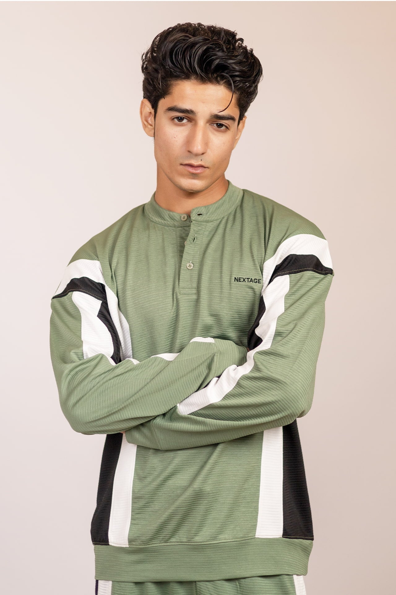 Nextage men’s track suit top close-up showing buttoned neckline and logo branding