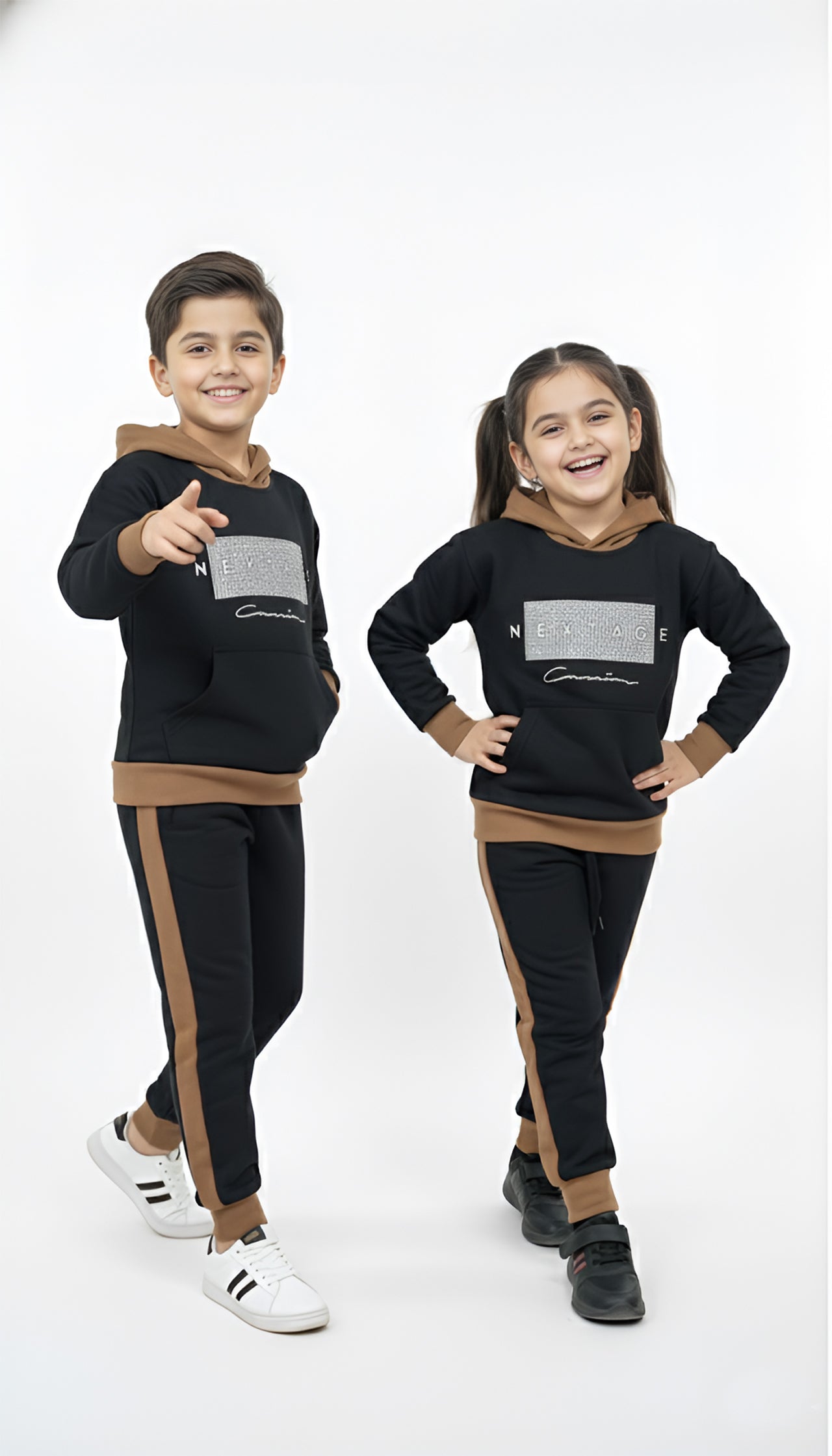 Two children wearing matching black and brown outfits on a white background