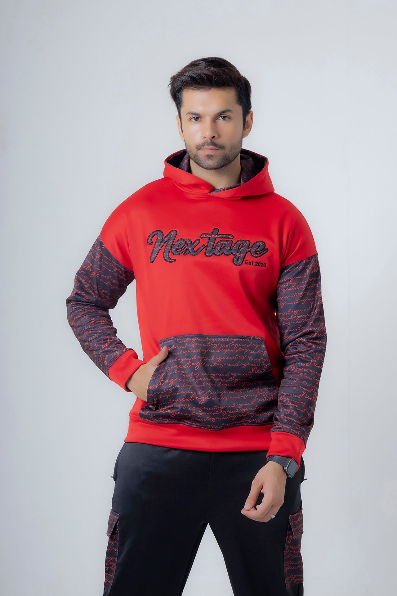 Man wearing Nextage red and black fleece hoodie tracksuit, front view showing signature design