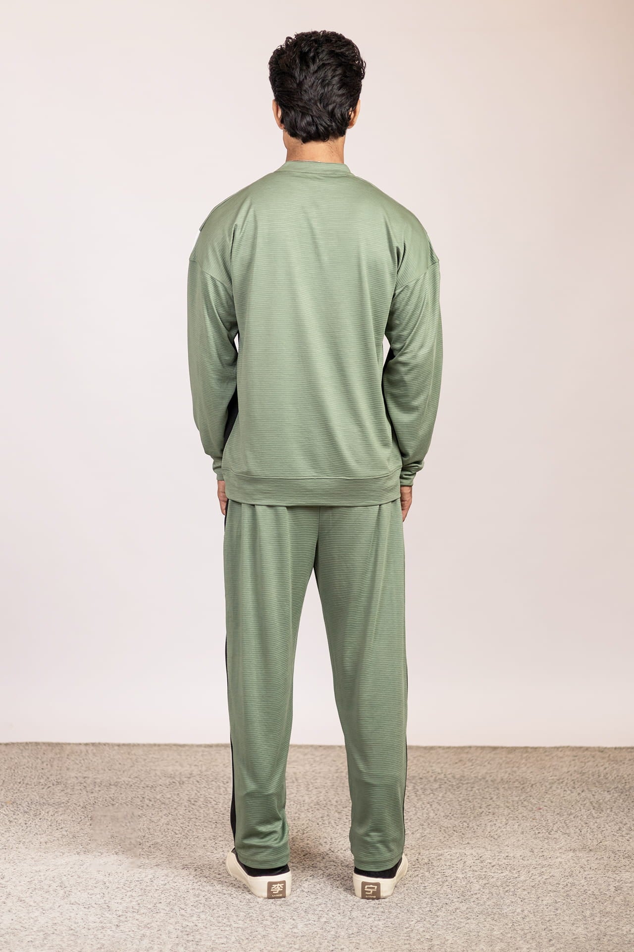Back view of Nextage men’s colorblock track suit in sage green