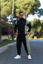 Nextage Oversized Black and Khaki Panel Tracksuit for men featuring a half-zip sweatshirt and tapered joggers, styled with white sneakers outdoors.