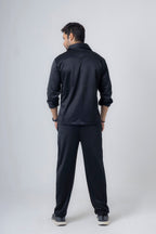 Back view of Nextage black fleece tracksuit showing safari-style jacket and relaxed jogger fit