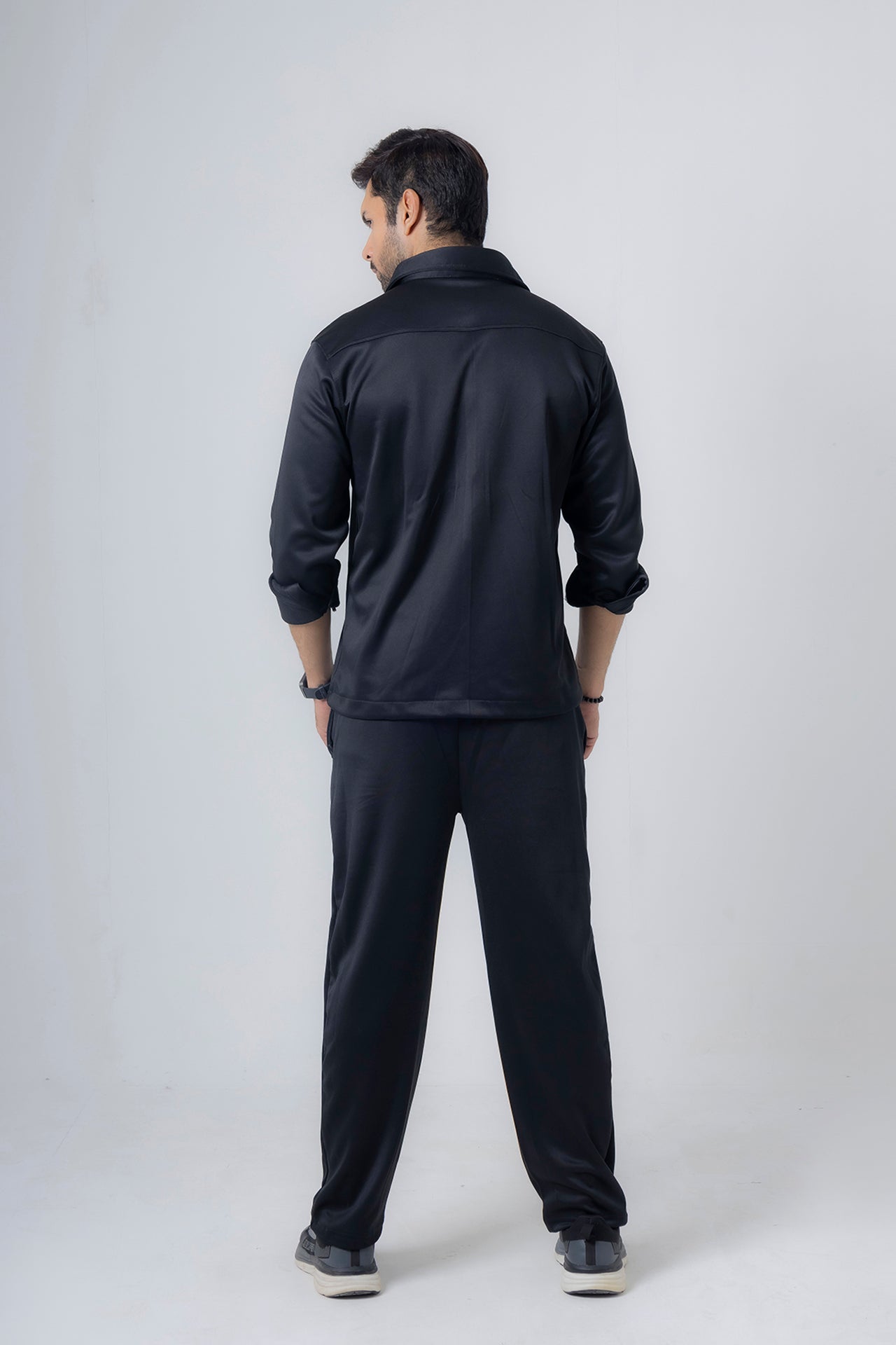 Back view of Nextage black fleece tracksuit showing safari-style jacket and relaxed jogger fit
